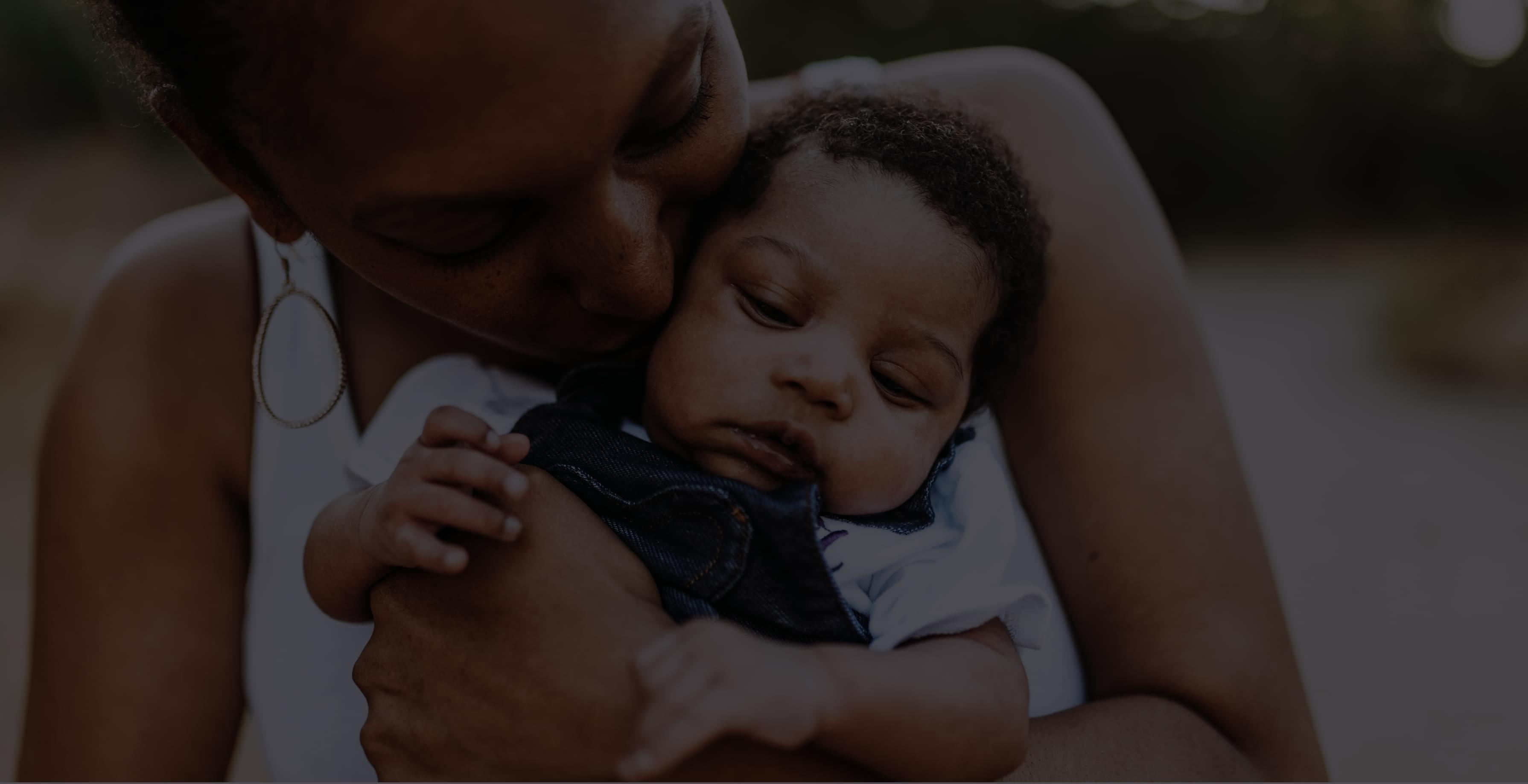 Woman holding baby.